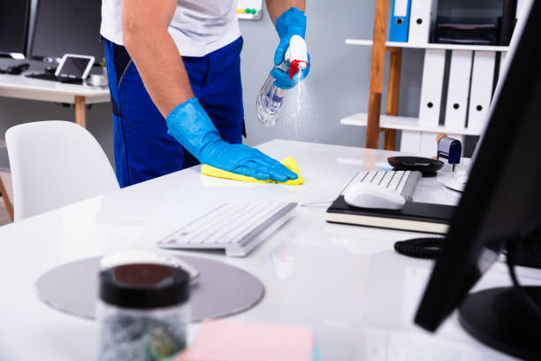 cleaner cleaning office with sanitizer and cleaning products